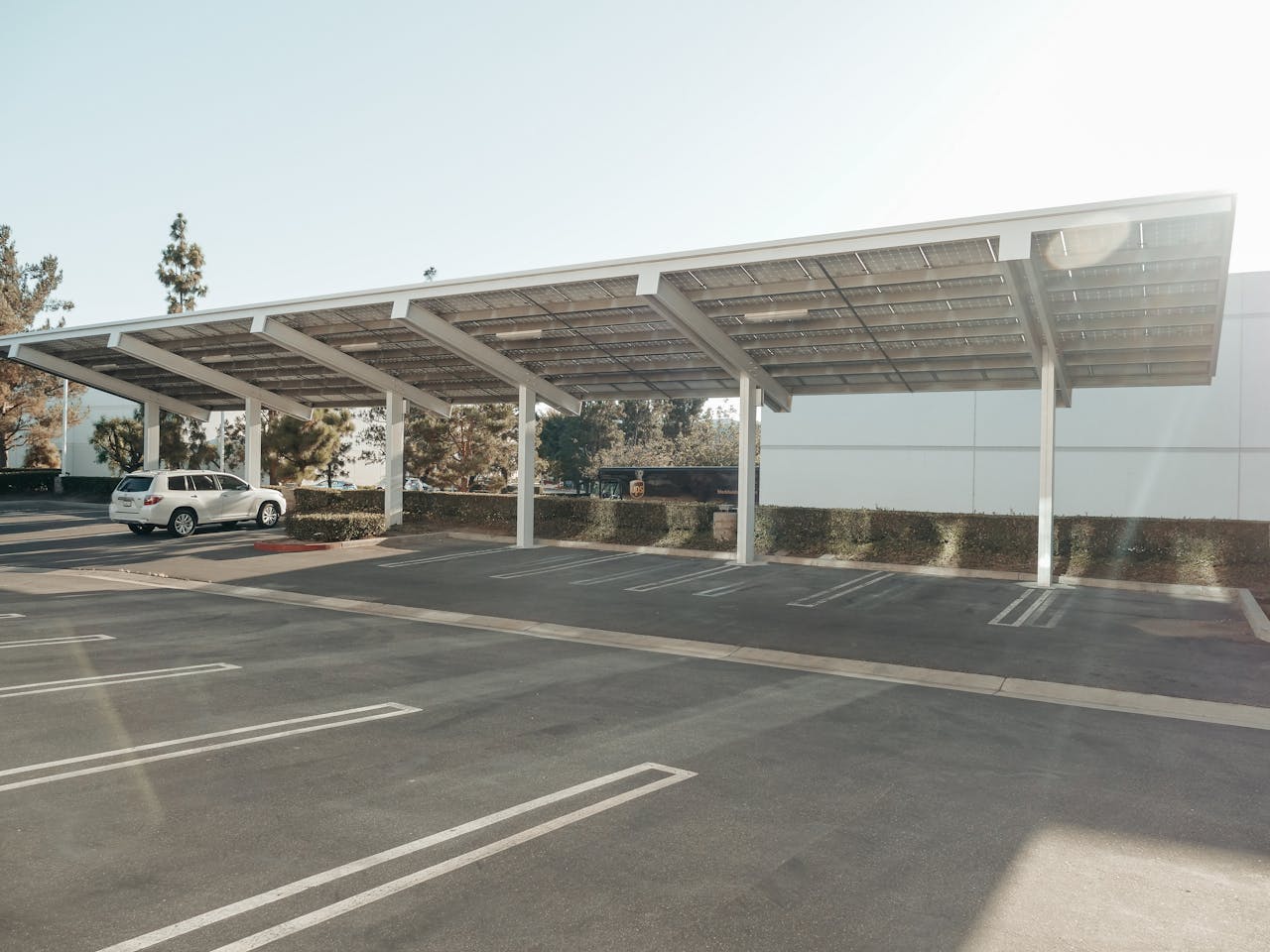 Solar panels installed over a parking lot, showcasing clean energy innovation outdoors.